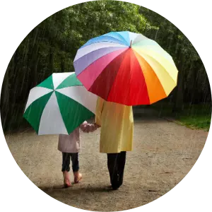 view of parent and child with umbrellas from the rear
