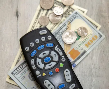 remote control with cash on a table