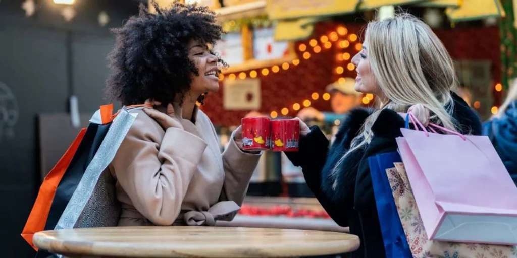 two women doing holiday shopping having coffee